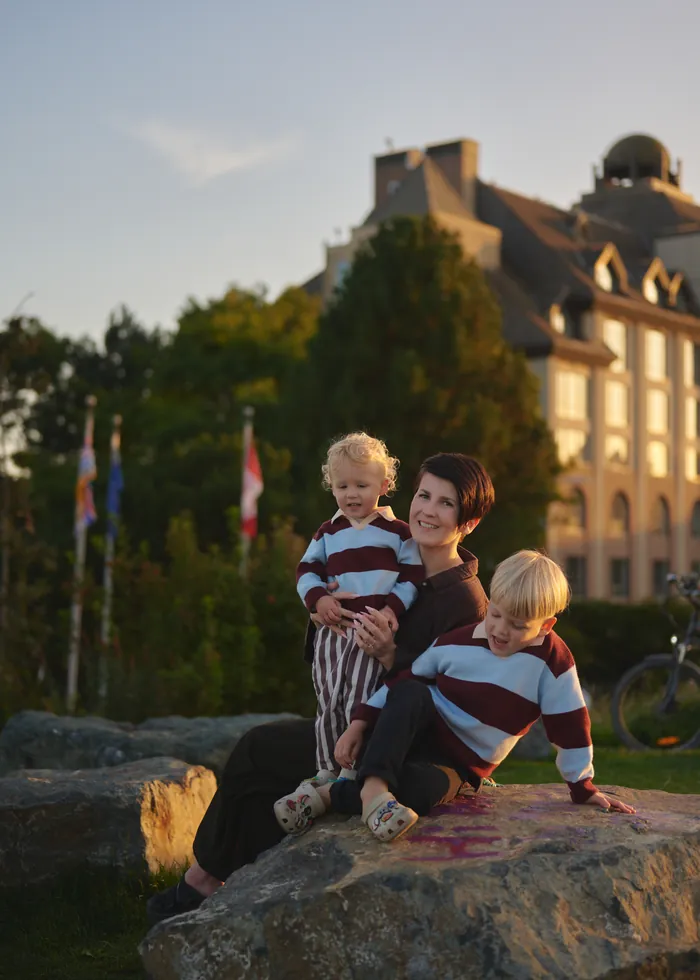 Oksana and the boys on the harbour rocks at sunset